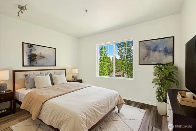 a bedroom with a bed and a potted plant