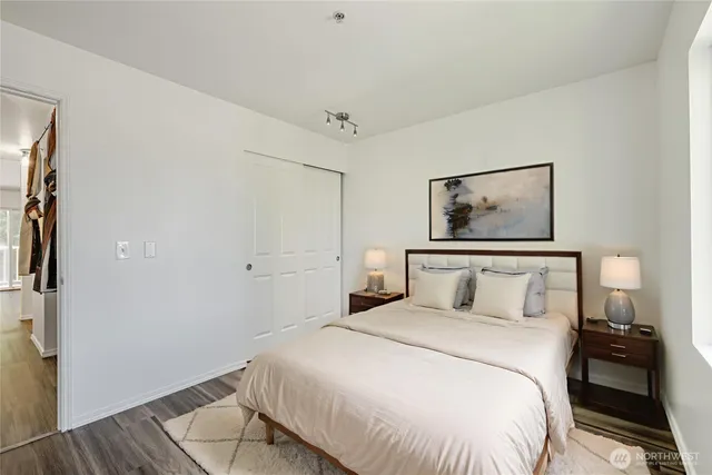 a bedroom with a bed and a painting on the wall