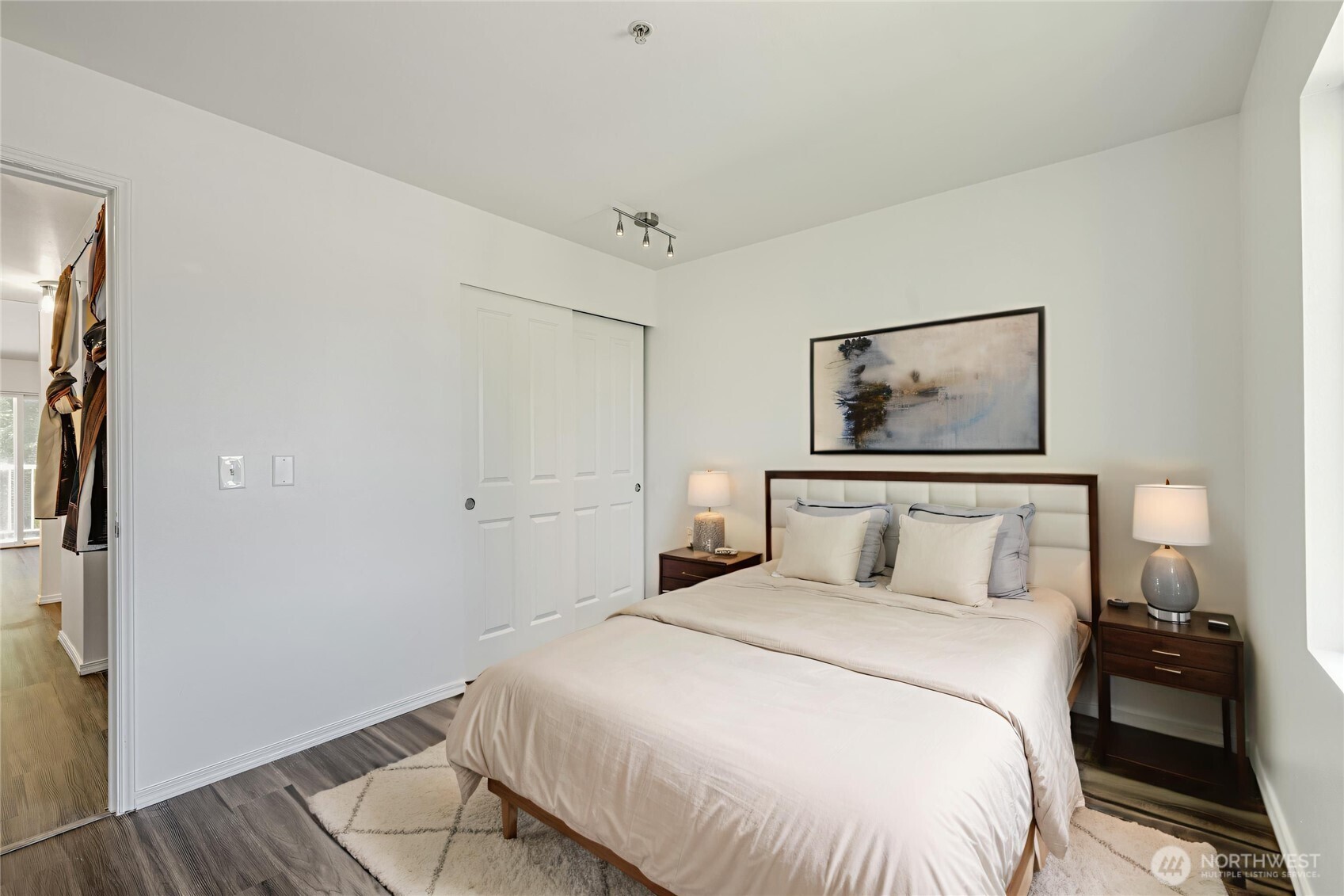 710 240th Way Southeast, Unit J302 Sammamish, WA 98074 - Photo 13 of 22 a bedroom with a bed and a painting on the wall