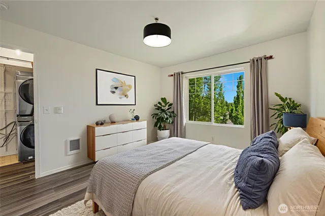 a spacious bedroom with a bed and a large window