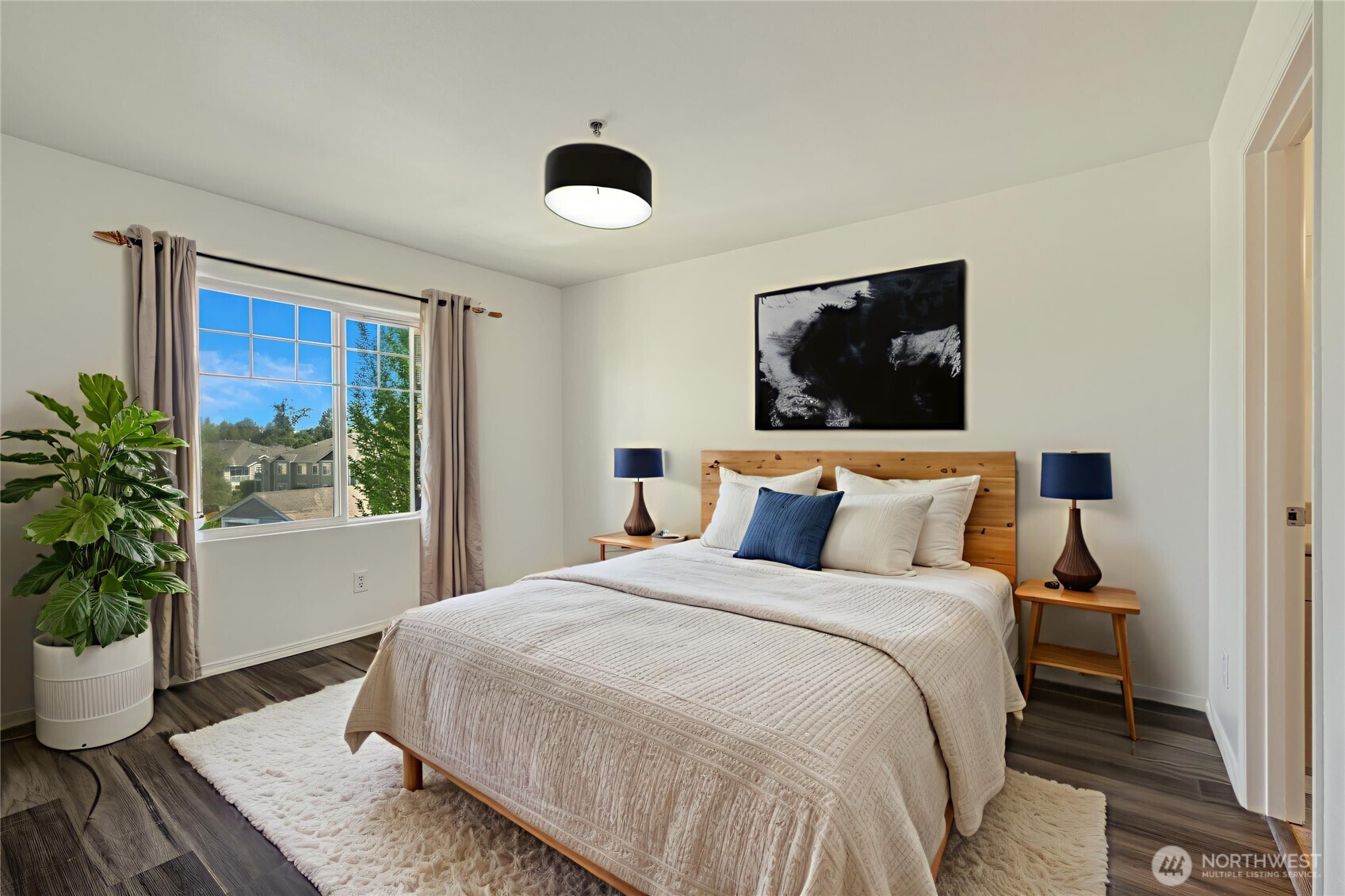 710 240th Way Southeast, Unit J302 Sammamish, WA 98074 - Photo 15 of 22 a bedroom with a large bed and a potted plant