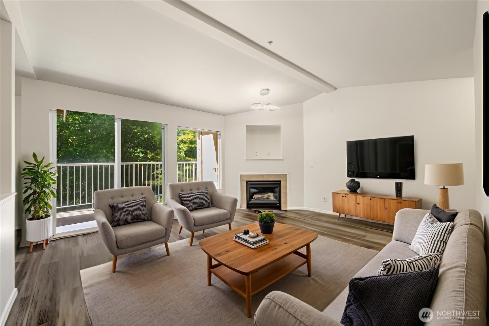 710 240th Way Southeast, Unit J302 Sammamish, WA 98074 - Photo 3 of 22 a living room with furniture fireplace and a flat screen tv