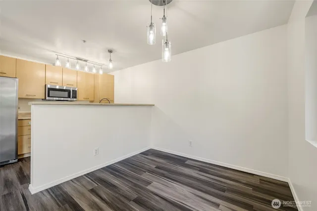 a view of a kitchen with wooden floor and a sink