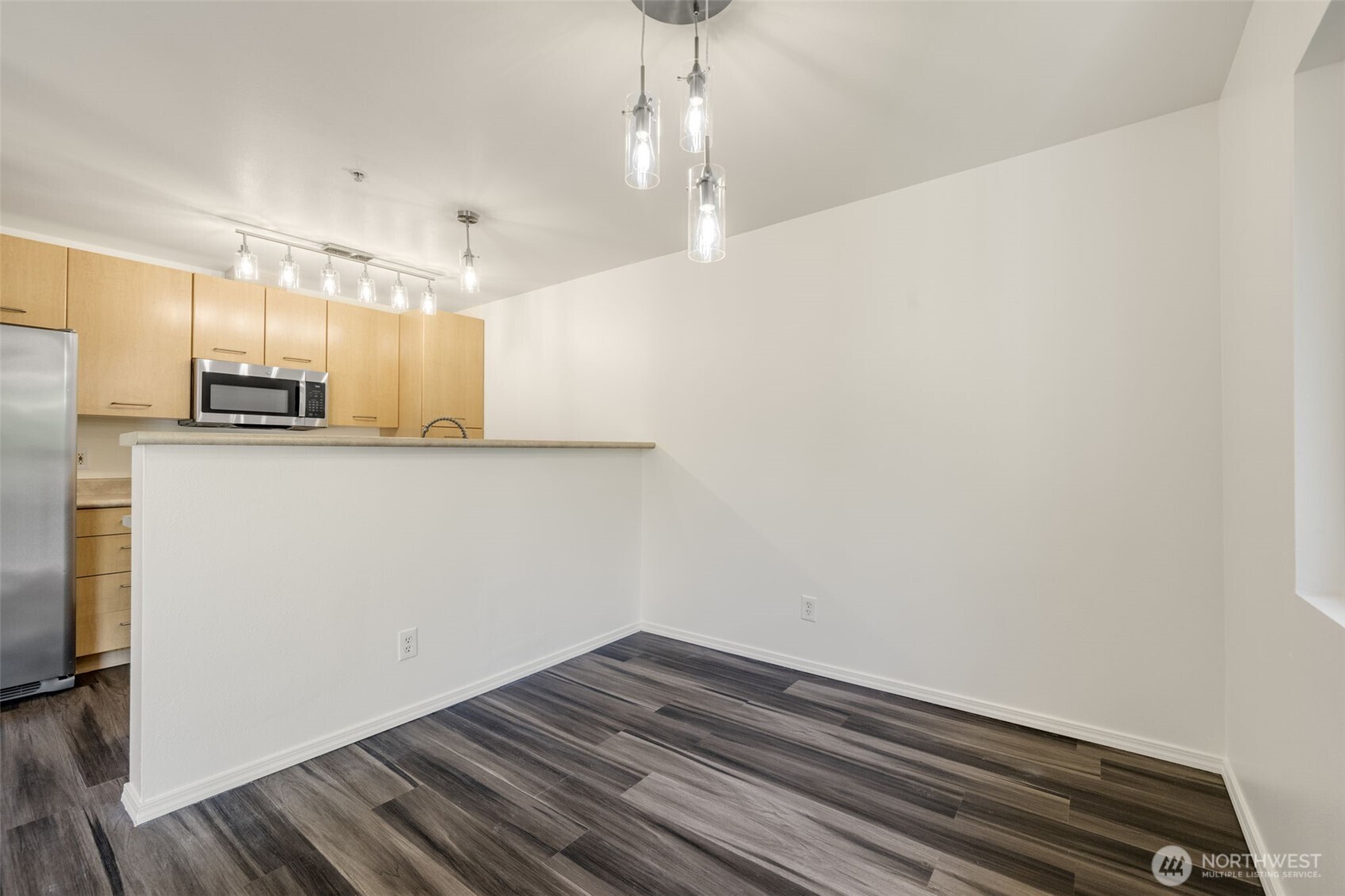 710 240th Way Southeast, Unit J302 Sammamish, WA 98074 - Photo 4 of 22 a view of a kitchen with wooden floor and a sink