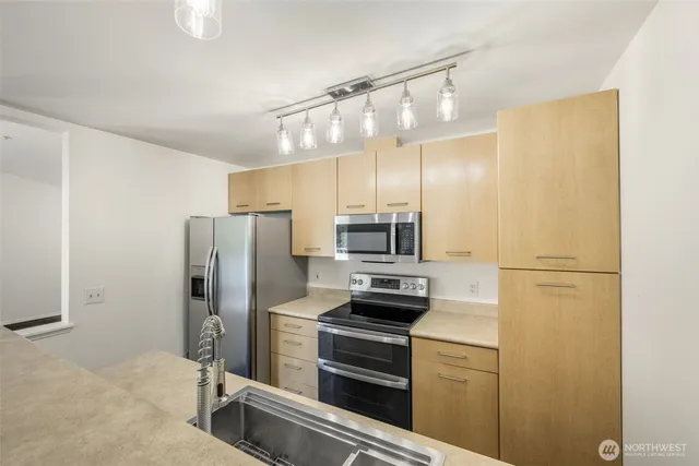 a kitchen with a refrigerator and microwave
