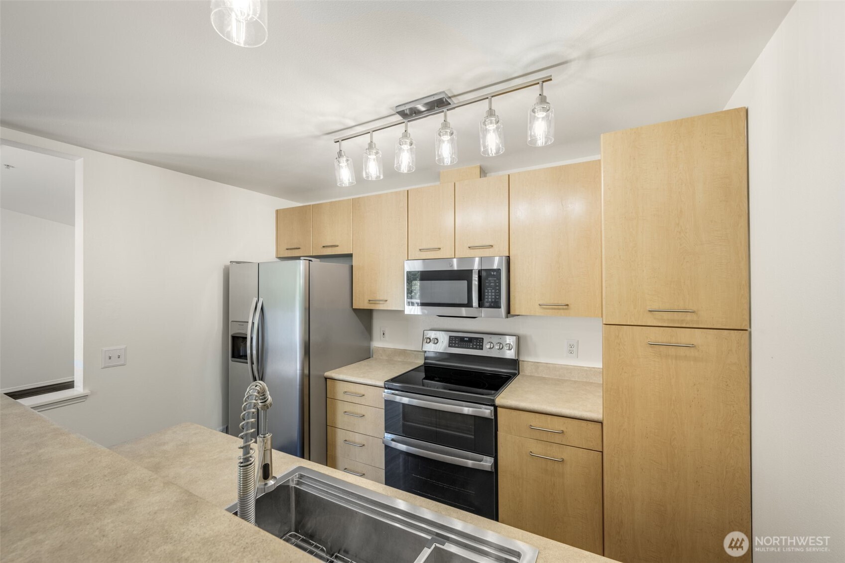 710 240th Way Southeast, Unit J302 Sammamish, WA 98074 - Photo 5 of 22 a kitchen with a refrigerator and microwave