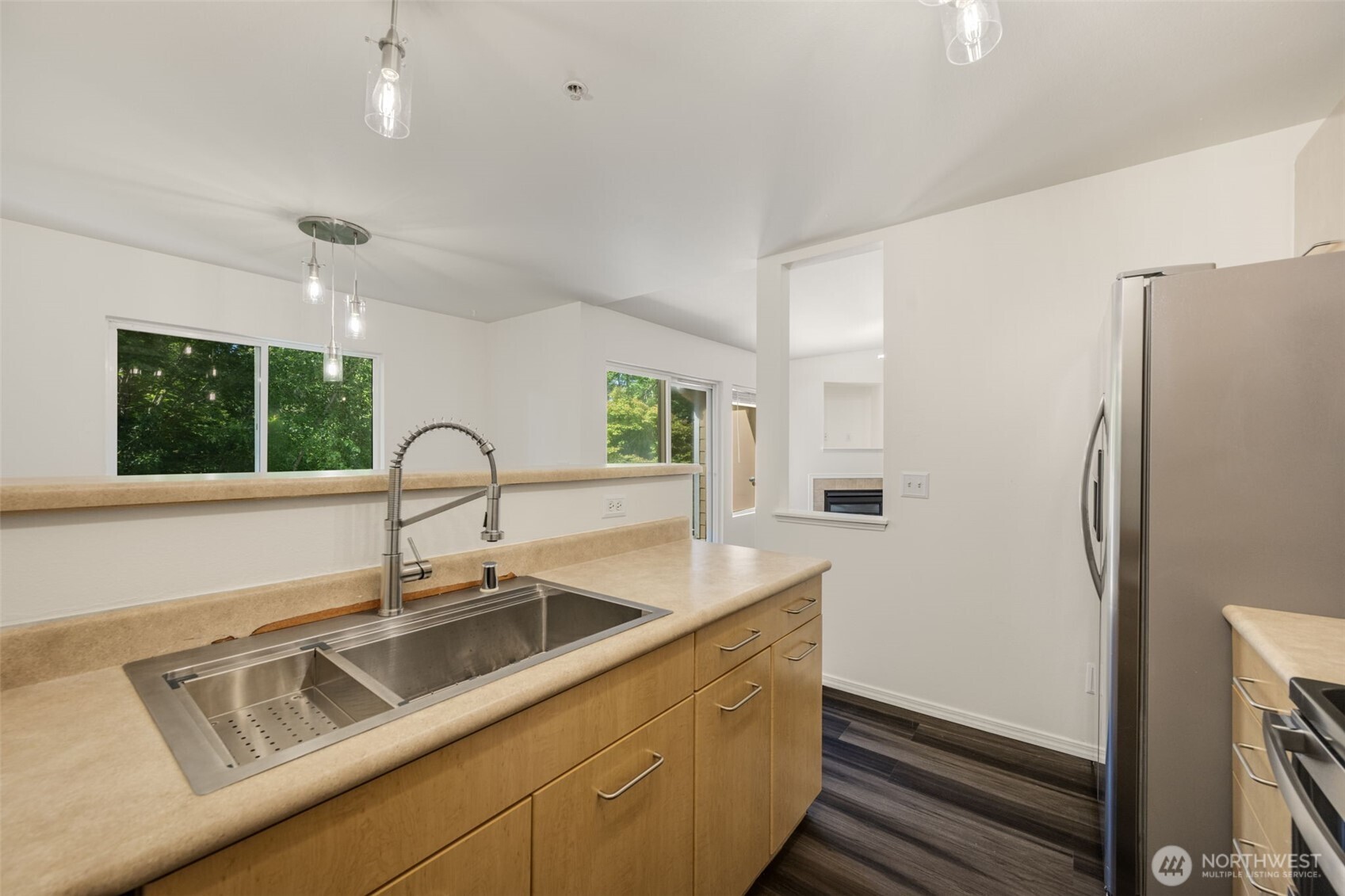 710 240th Way Southeast, Unit J302 Sammamish, WA 98074 - Photo 6 of 22 a kitchen with a sink and a refrigerator