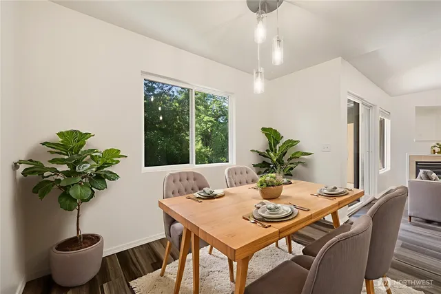 a view of a dining room with furniture window and wooden floor
