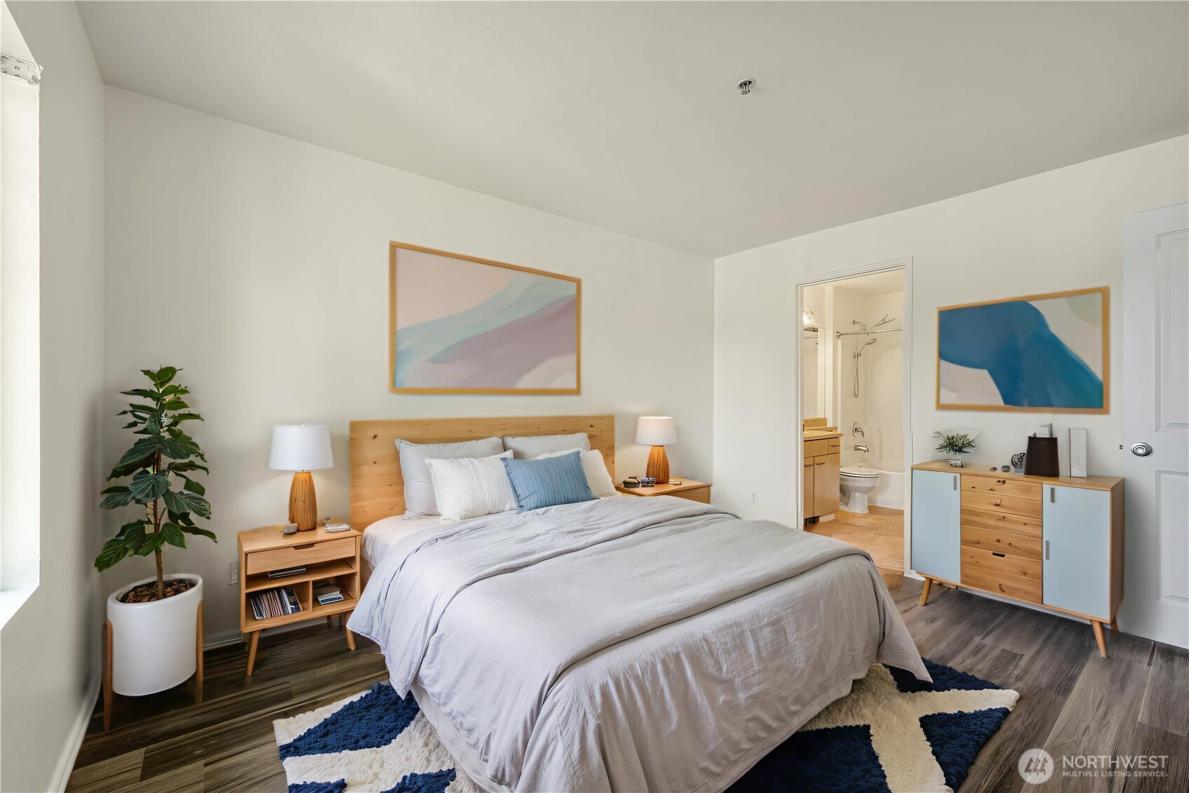 710 240th Way Southeast, Unit J302 Sammamish, WA 98074 - Photo 9 of 22 a bedroom with a bed and wooden floor