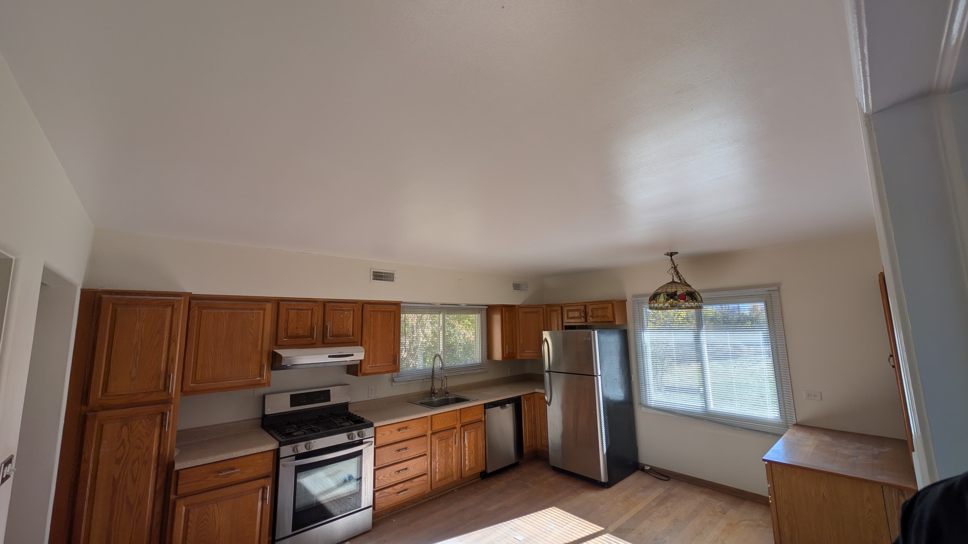 811 Hoyle Road Lombard, IL 60148 - Photo 12 of 22 a kitchen with stainless steel appliances a stove a sink and a refrigerator