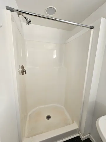 a bathroom with a shower and a toilet