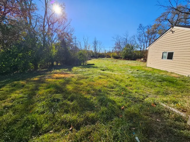 a view of a backyard of the house