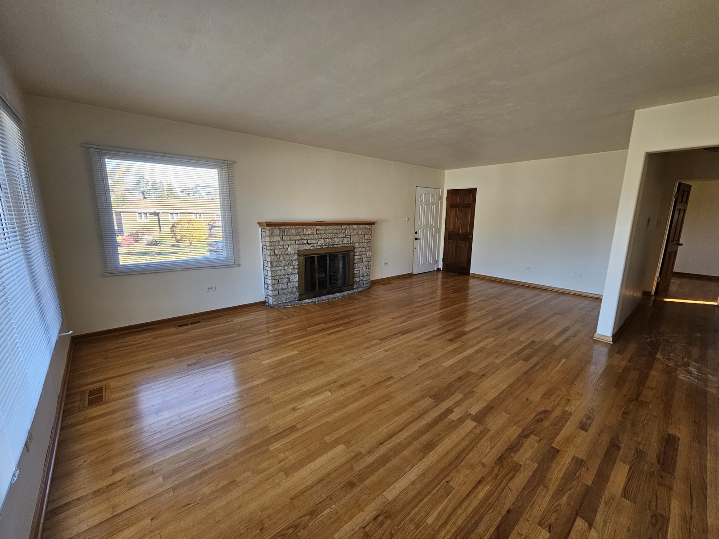 811 Hoyle Road Lombard, IL 60148 - Photo 4 of 22 a view of an empty room with wooden floor and a window