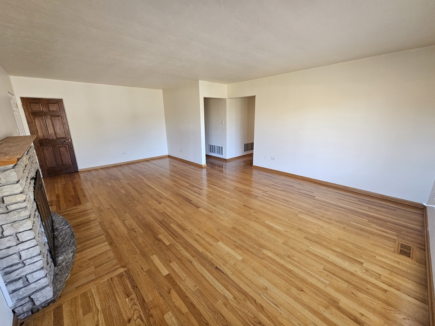 811 Hoyle Road Lombard, IL 60148 - Photo 5 of 22 a view of an empty room with wooden floor and a window