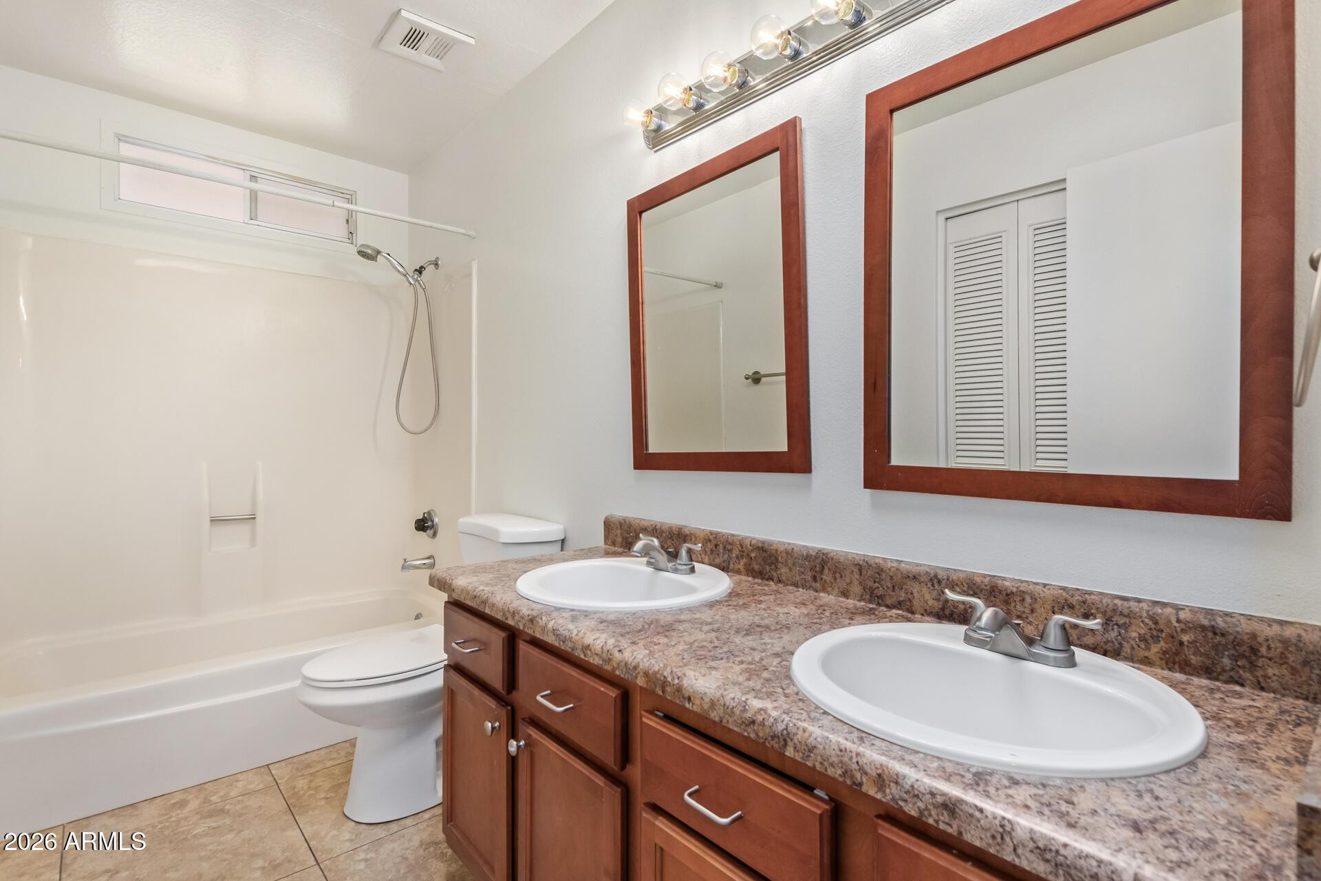 3929 South Pine Street Tempe, AZ 85282 - Photo 14 of 23 a bathroom with a granite countertop sink toilet a mirror and bathtub