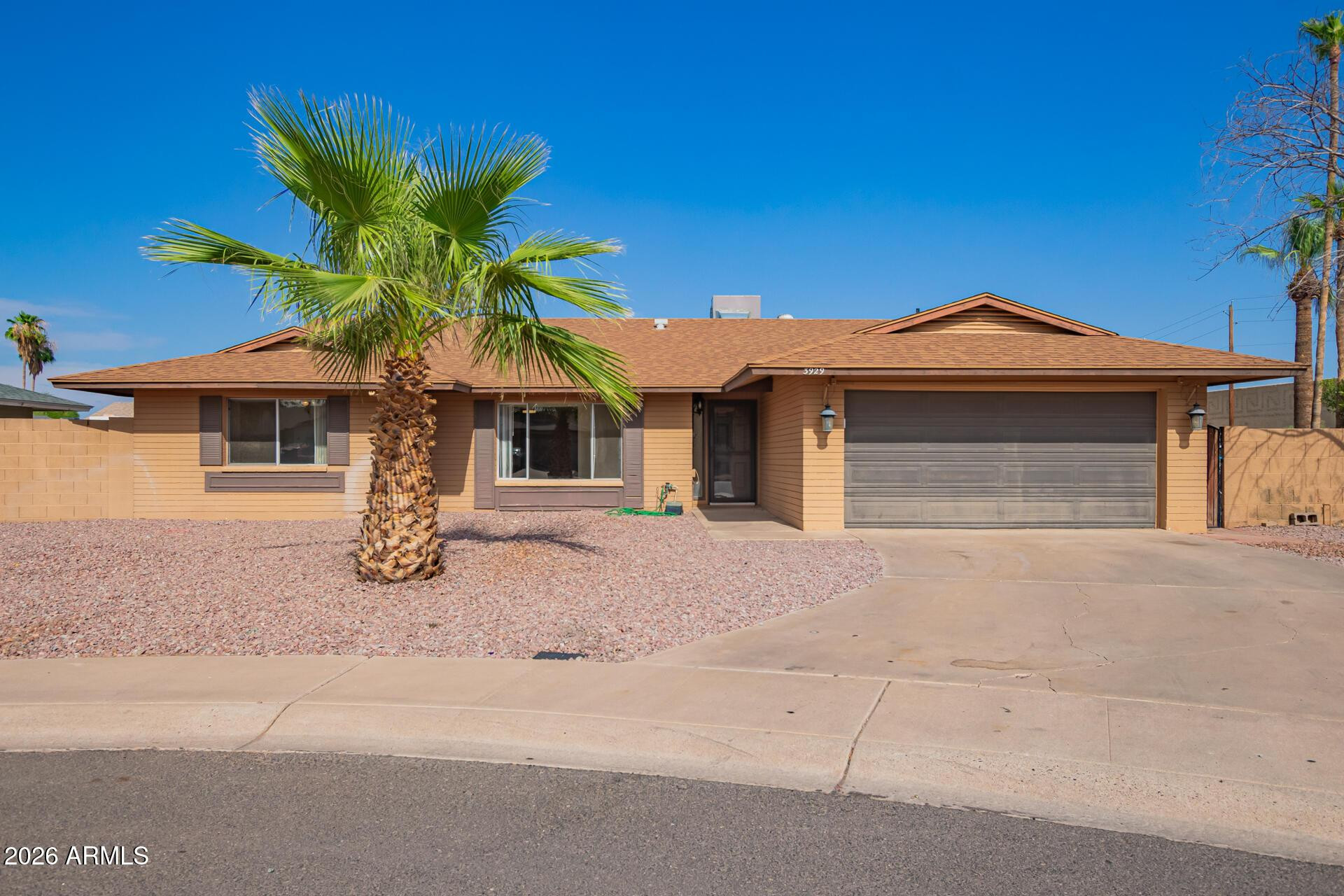 3929 South Pine Street Tempe, AZ 85282 - Photo 2 of 23 a front view of a house with a yard and garage