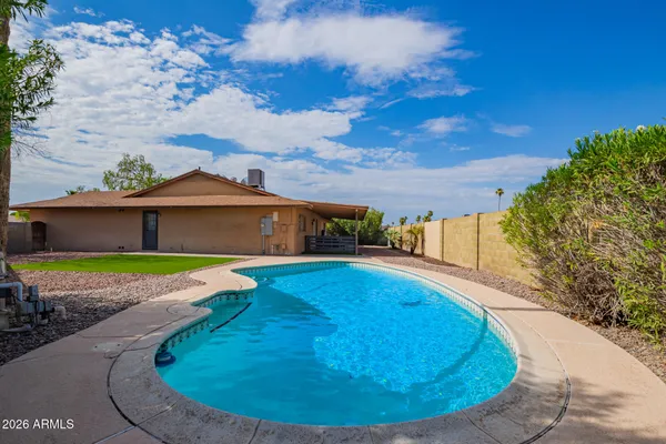 a view of a swimming pool with a yard