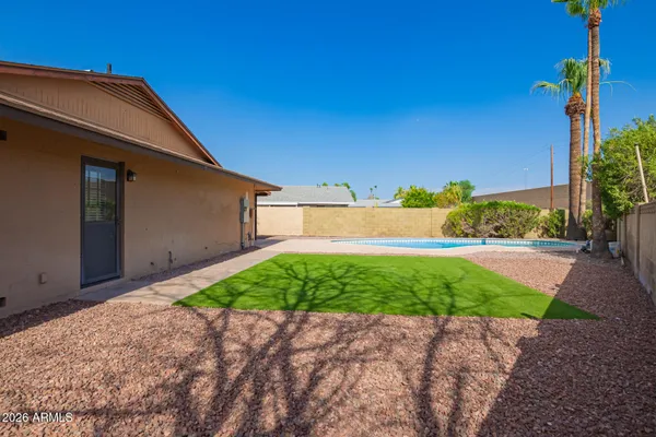 a backyard of a house with plants and trees