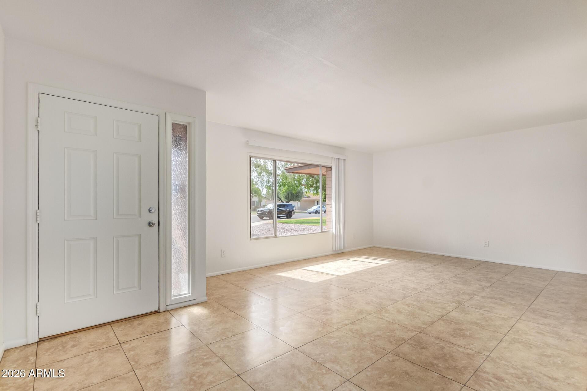 3929 South Pine Street Tempe, AZ 85282 - Photo 3 of 23 a view of an empty room with a window