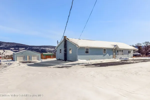 a view of a house with a snow on the road
