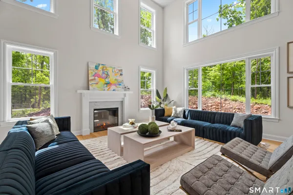 a living room with furniture large window and a fireplace