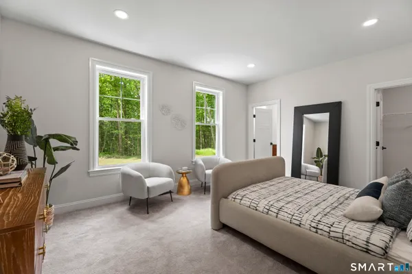 a bedroom with a bed and windows