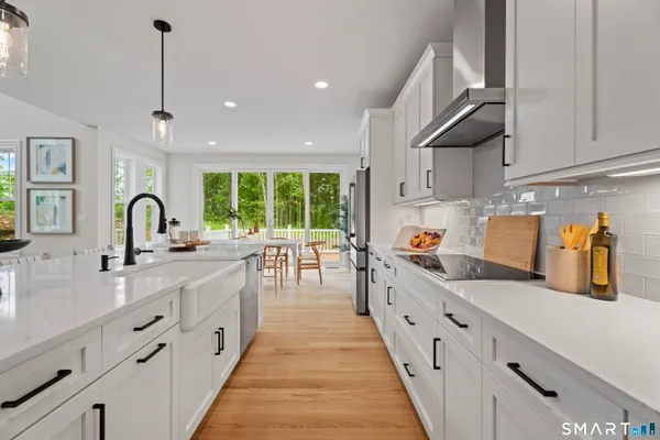 a kitchen with counter top space a sink stainless steel appliances and cabinets