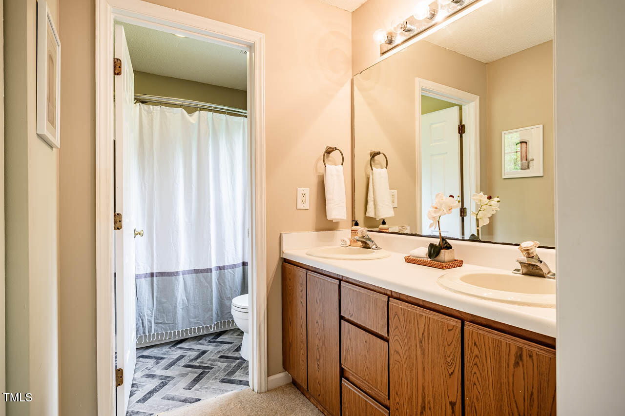3 Little Stone Circle Durham, NC 27703 - Photo 21 of 27 a bathroom with a double vanity sink and a mirror