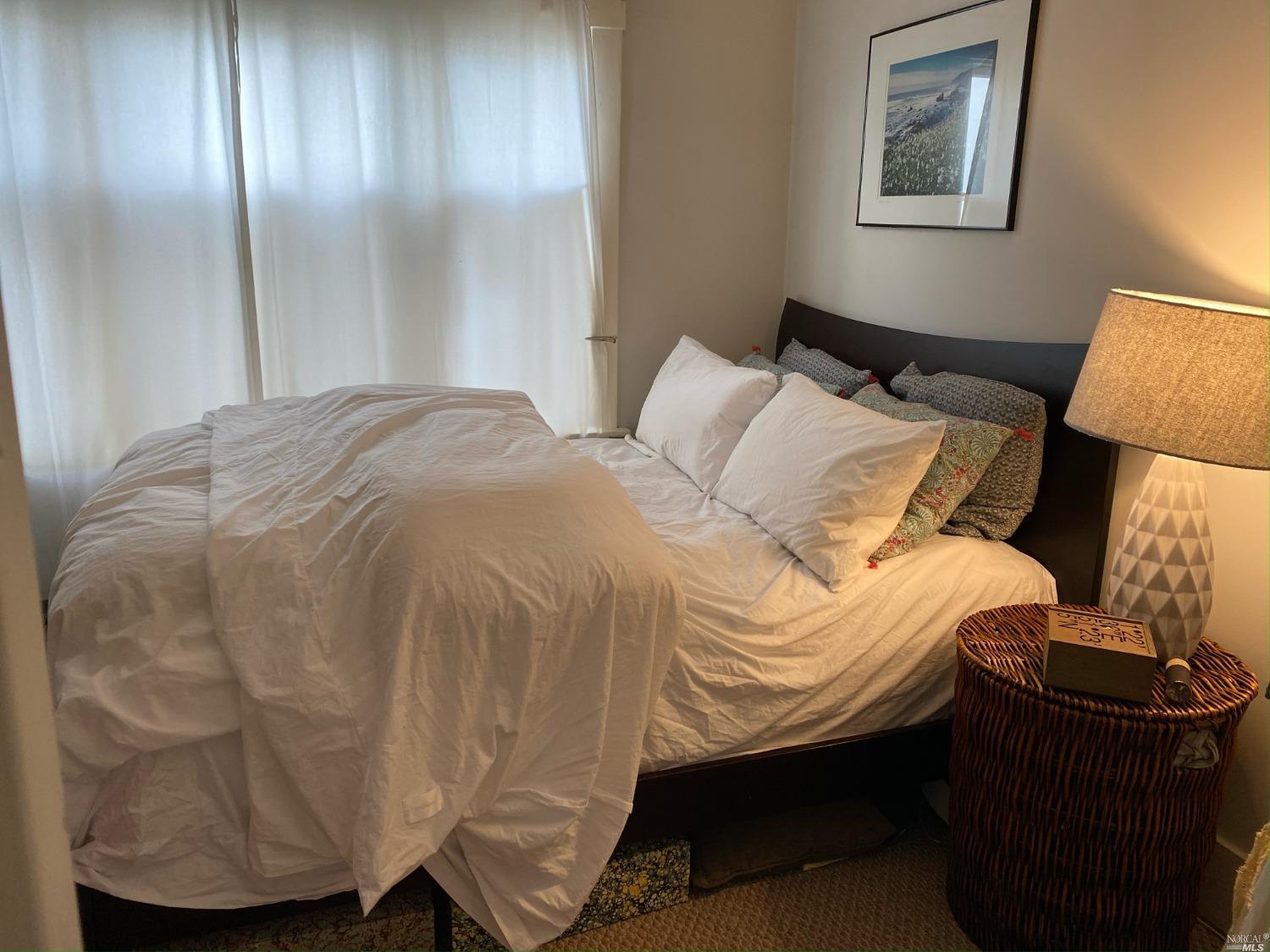 6 West Court, Unit B Sausalito, CA 94965 - Photo 8 of 9 a bedroom with a bed and wooden floor