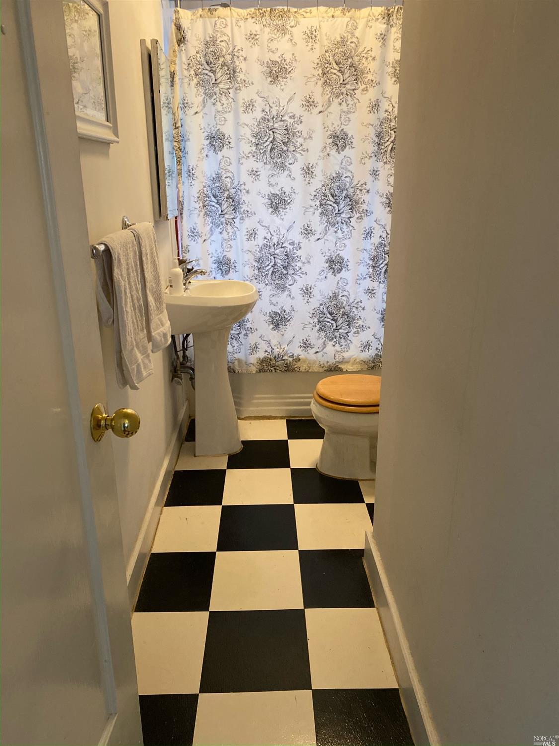 6 West Court, Unit B Sausalito, CA 94965 - Photo 9 of 9 a bathroom with a toilet and a shower curtain