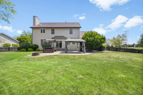 a front view of a house with yard and green space