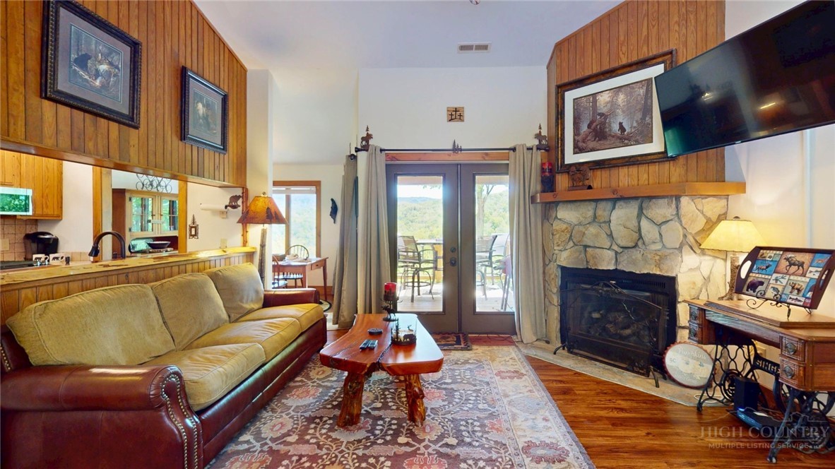 250 Ridgeview Road, Unit 43 Sugar Mountain, NC 28604 - Photo 7 of 21 a living room with furniture a fireplace and a flat screen tv