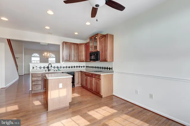 a large kitchen with stainless steel appliances granite countertop a sink and a stove