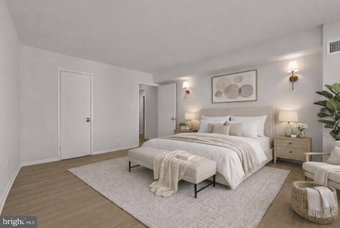 4620 North Park Avenue, Unit 1211E Chevy Chase, MD 20815 - Photo 13 of 37 a spacious bedroom with a bed and a painting on the wall