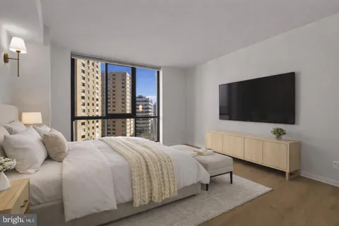 a bedroom with a bed and a flat screen tv