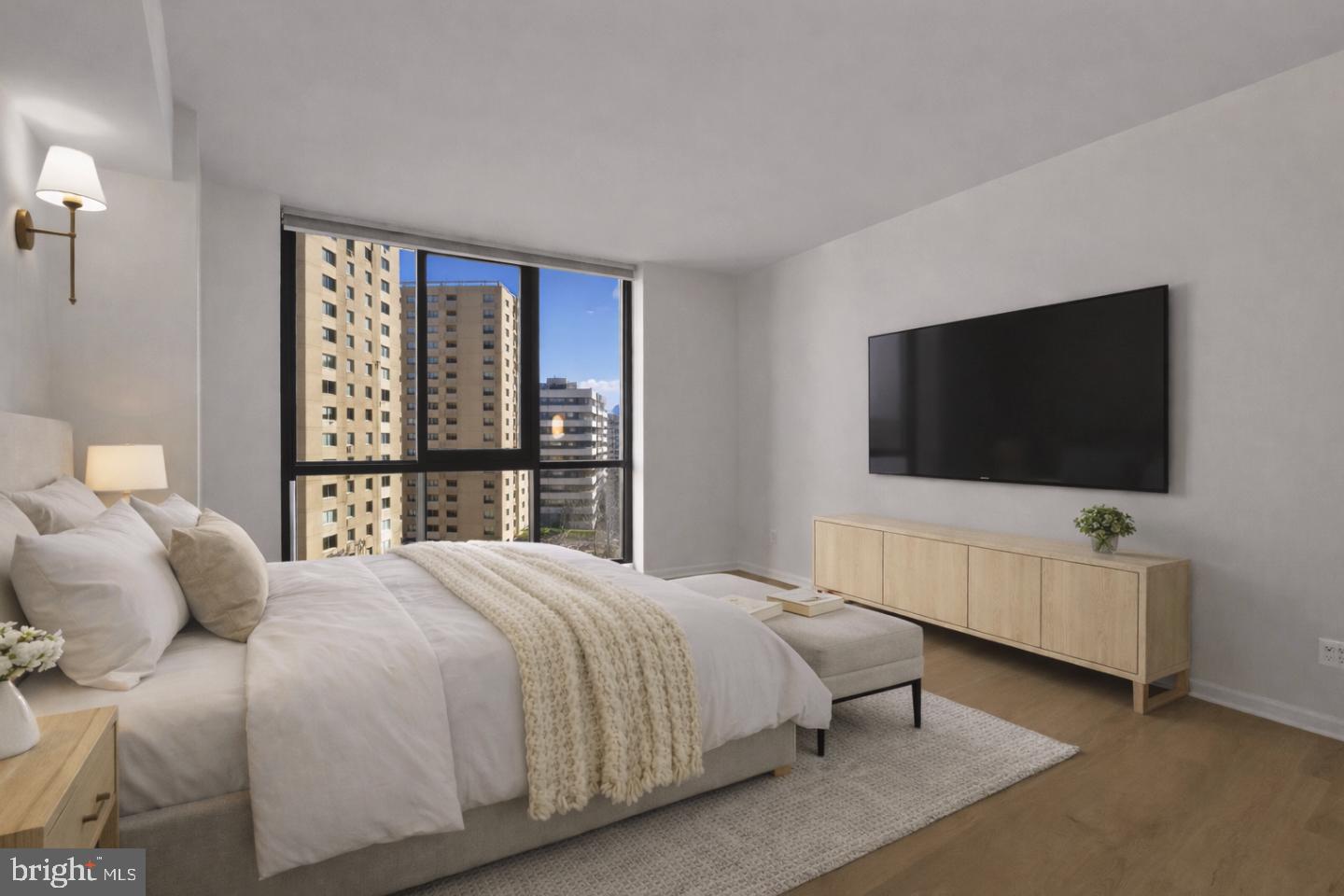 4620 North Park Avenue, Unit 1211E Chevy Chase, MD 20815 - Photo 15 of 37 a bedroom with a bed and a flat screen tv