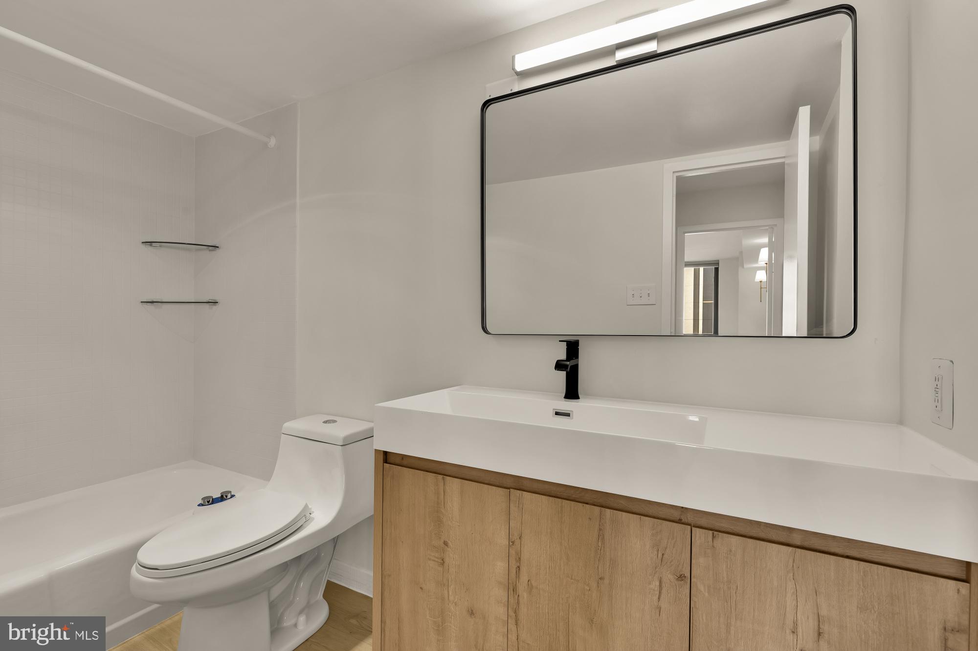 4620 North Park Avenue, Unit 1211E Chevy Chase, MD 20815 - Photo 17 of 37 a bathroom with a sink a toilet and shower