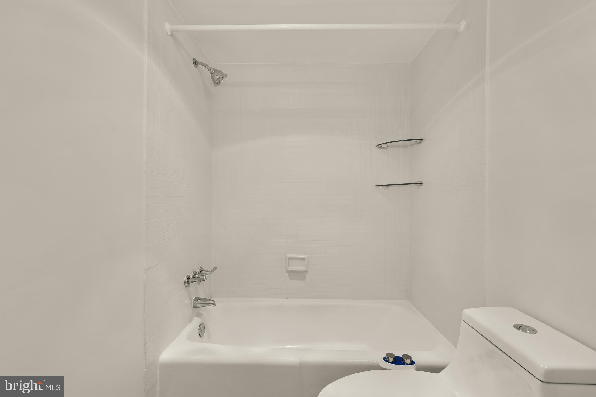 4620 North Park Avenue, Unit 1211E Chevy Chase, MD 20815 - Photo 18 of 37 a bathroom with a bathtub and a shower