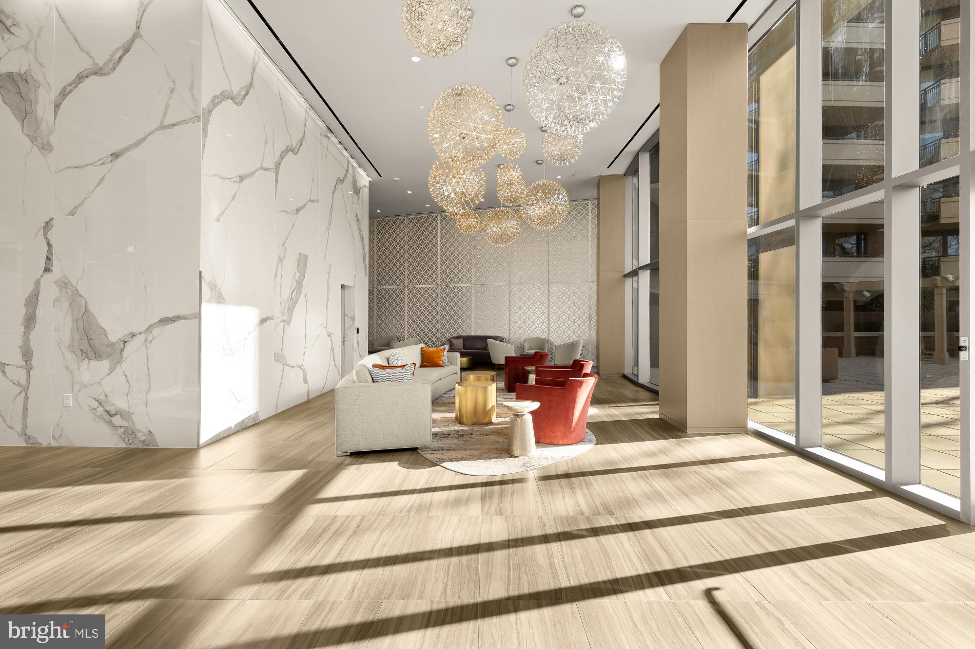 4620 North Park Avenue, Unit 1211E Chevy Chase, MD 20815 - Photo 25 of 37 a view of a living room with a large window and chandelier