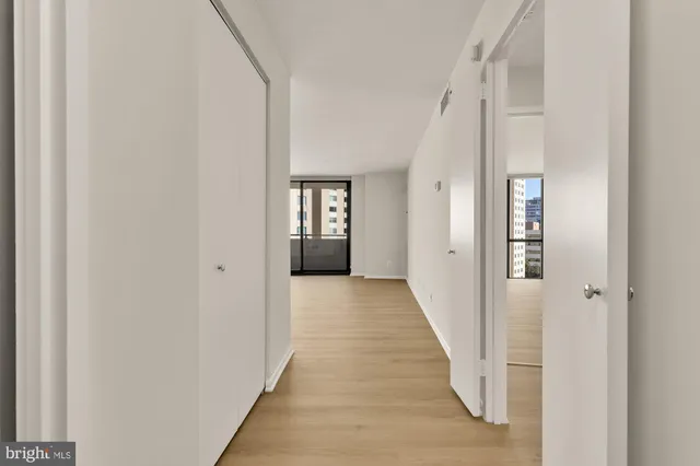 a view of a hallway with wooden floor and staircase