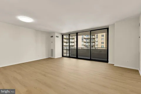 a view of an empty room with glass door
