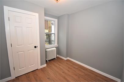 210 Chesterfield Road Pittsburgh, PA 15213 - Photo 7 of 11 an empty room with wooden floor and windows