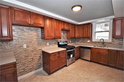 210 Chesterfield Road Pittsburgh, PA 15213 - Photo 9 of 11 a kitchen with stainless steel appliances granite countertop wooden cabinets a stove a sink and a window