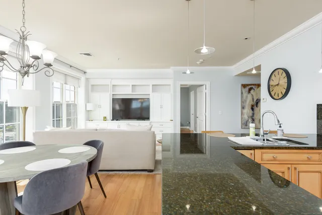 a living room with furniture a flat screen tv and a large window