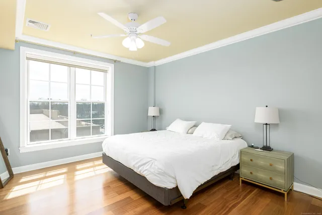 a bedroom with a bed and a large window