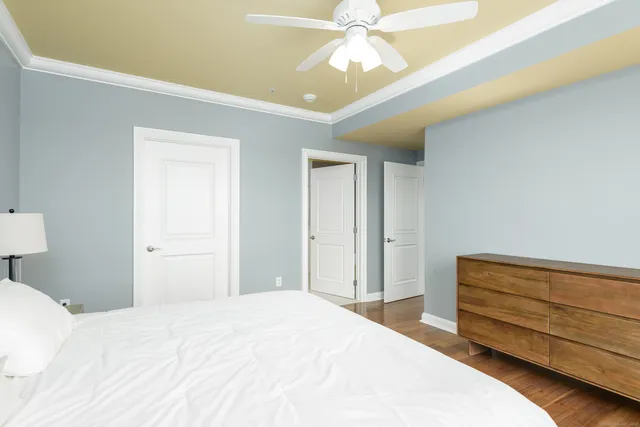 a bedroom with a bed and a chandelier