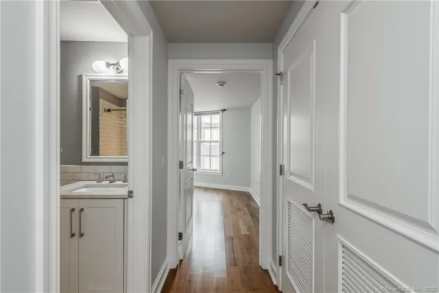 a view of a hallway with wooden floor