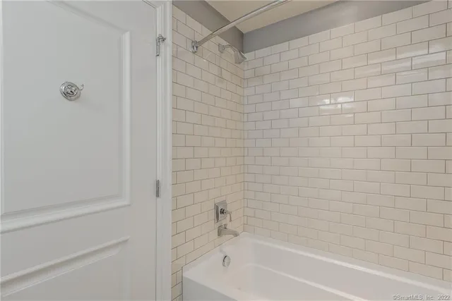 a bathroom with a shower and a bath tub