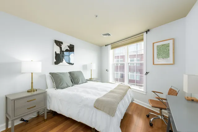 a bedroom with a bed and a window