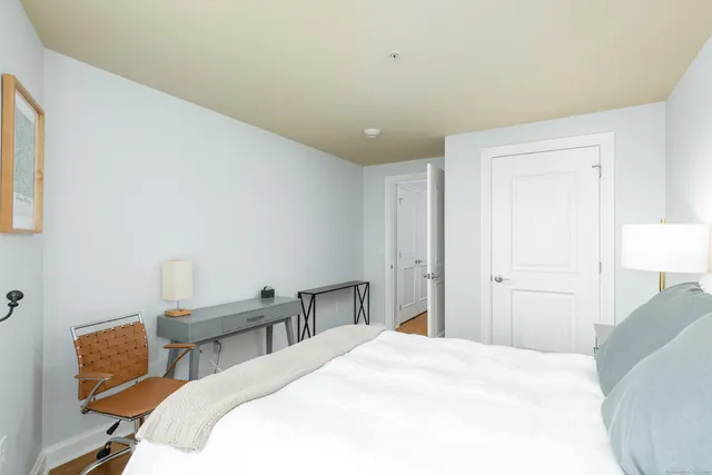 a bedroom with a bed and a table in it